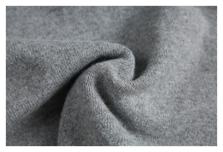Close-up showing the soft-looking knit texture of gray sweater fabric.