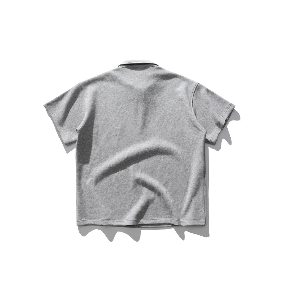 Back view of gray short-sleeve polo-style top laid flat, showing collar and plain back