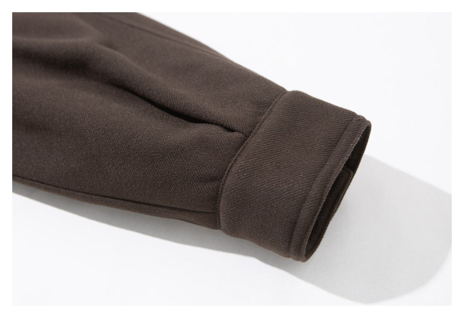 Close-up of a dark brown garment sleeve ending in a wide cuff.