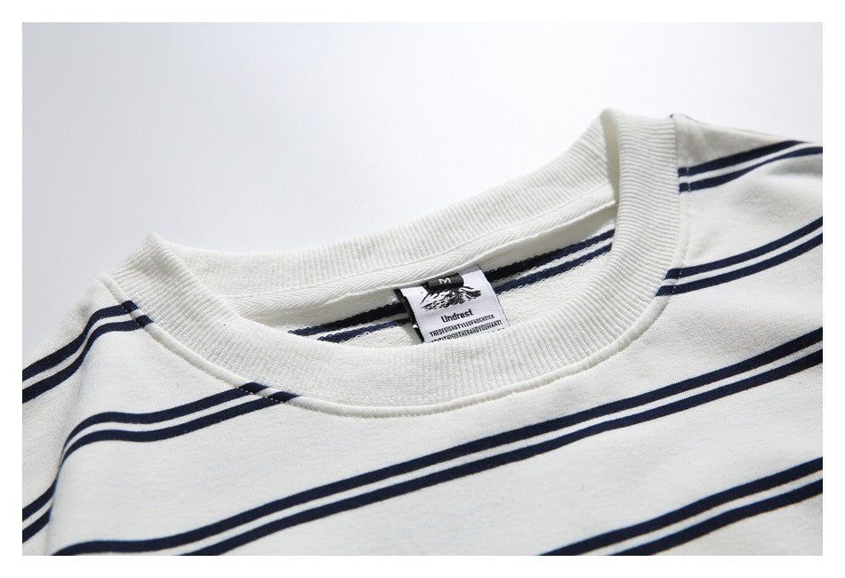 Close-up of the striped top's ribbed crew neckline and attached neck label.