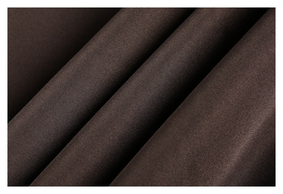 Close-up of dark brown woven garment fabric arranged in soft folds.