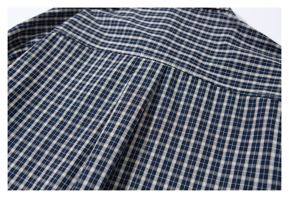 Close-up of the back yoke and pleat on a navy checked shirt.