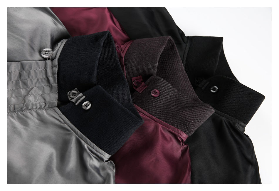 Close-up of gray, burgundy, and black jackets showing contrasting ribbed collars and buttons.