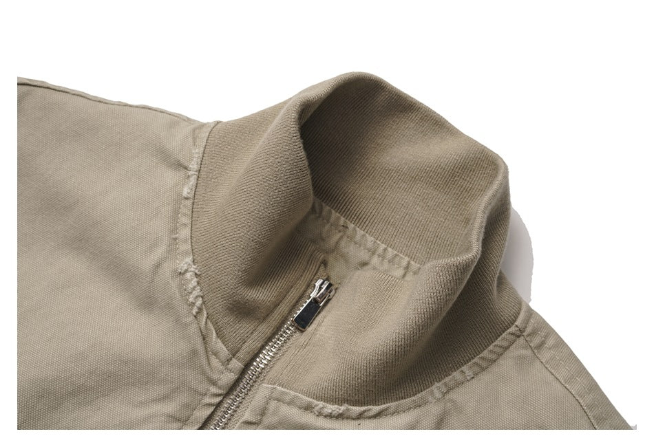 Close-up of the jacket’s ribbed stand collar and silver front zipper.