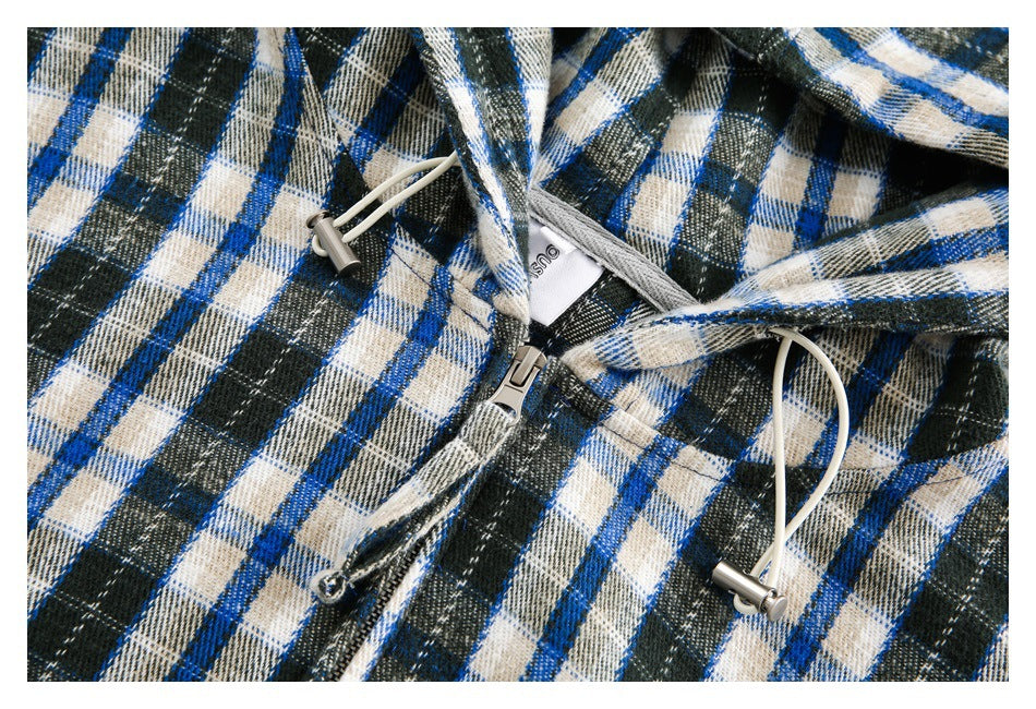 Close-up of the plaid jacket's hood drawstrings, metal toggles and front zipper.