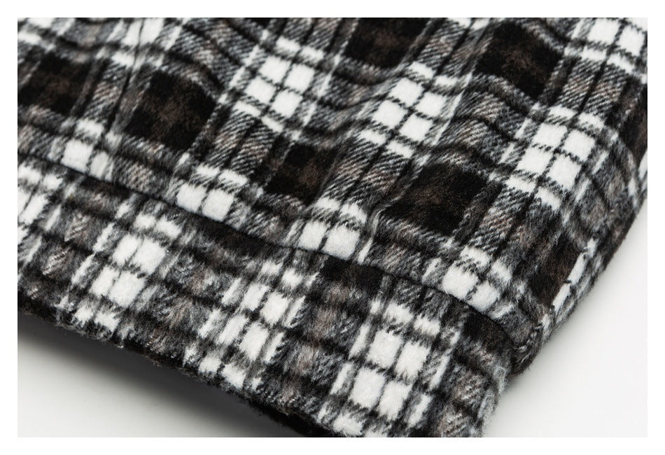 Close-up of the black-and-white plaid garment hem and stitched edge.