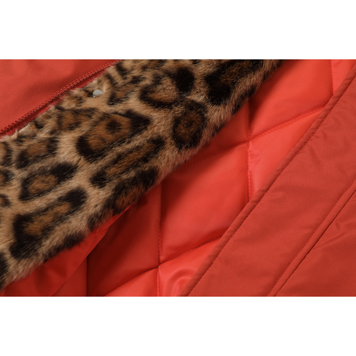 Close-up of leopard-print lining and red quilted interior inside a rust-red jacket.