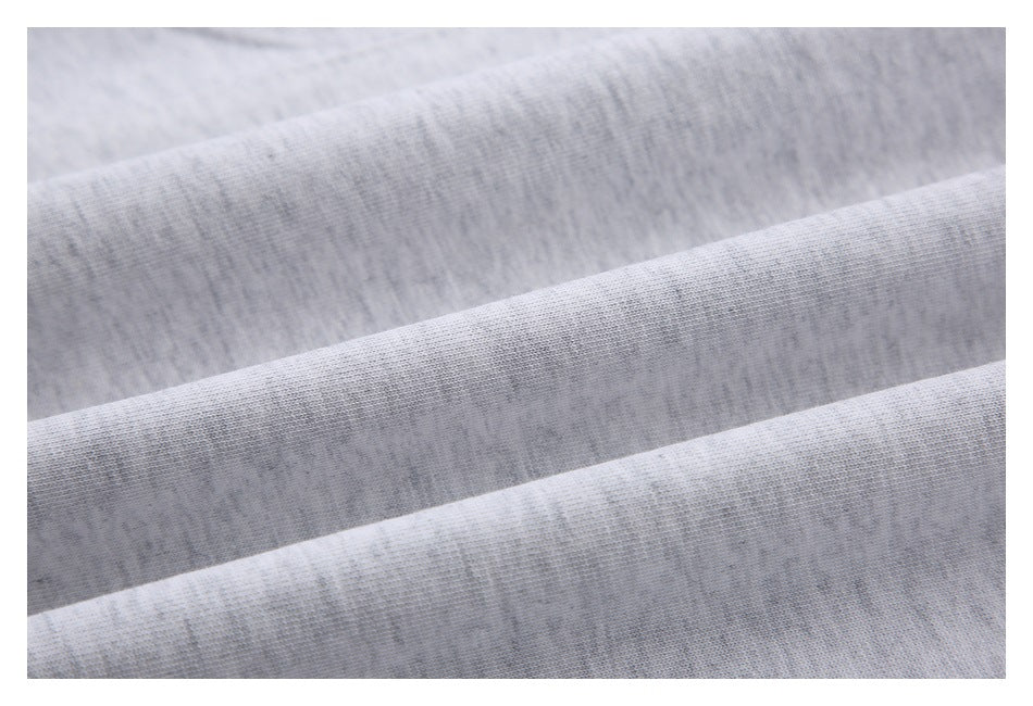 Close-up of light gray heathered fabric arranged in soft folds.