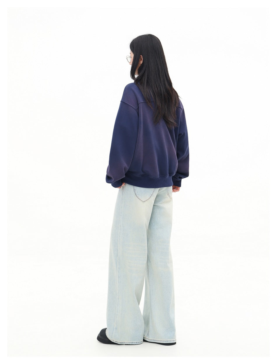 Rear view of a model wearing the navy sweatshirt, showing its plain back and ribbed hem.