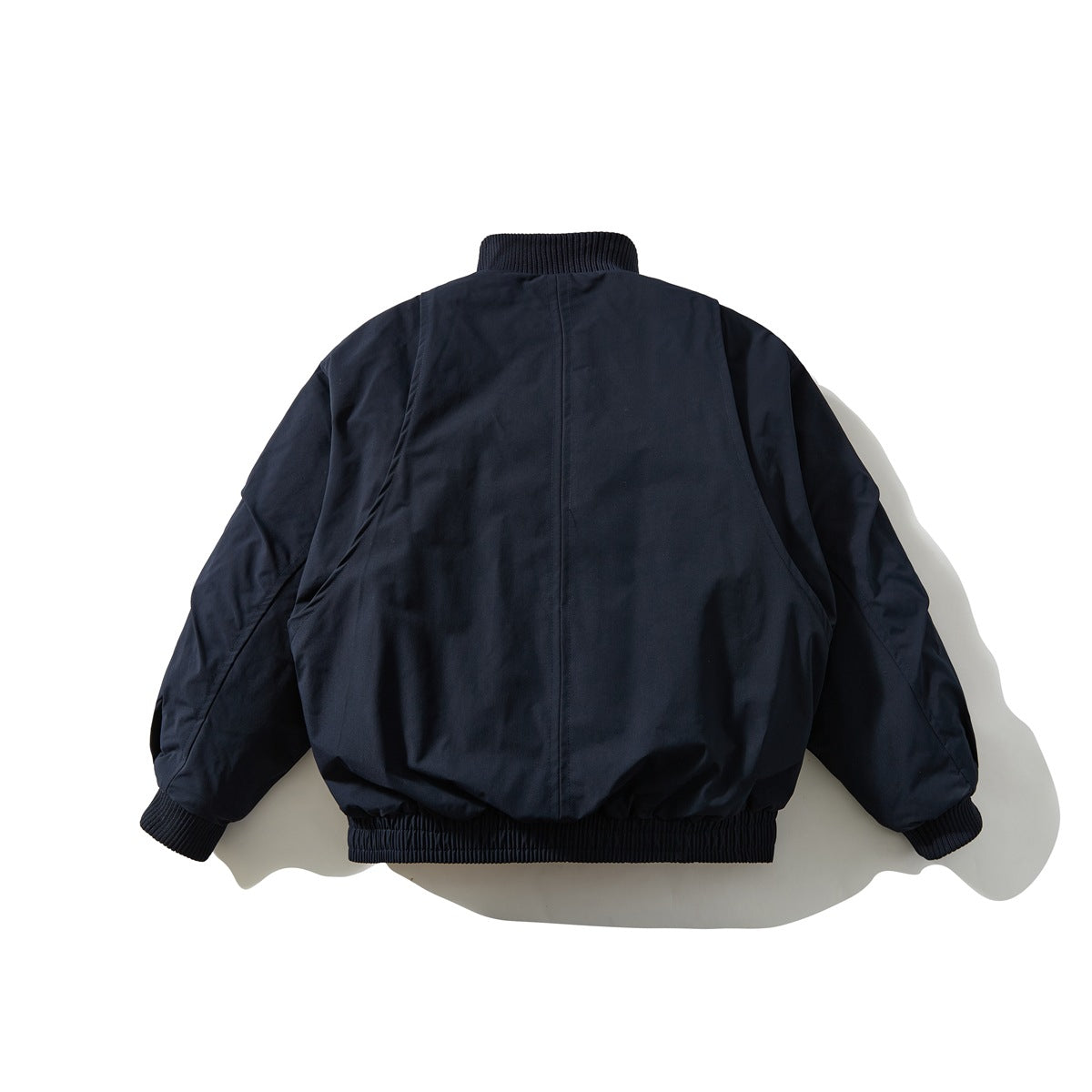 Back view of a navy zip-up jacket with a ribbed collar, cuffs, and hem.