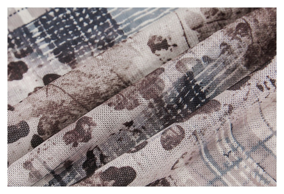 Macro view of the garment's textured knit surface and abstract brown, cream, and blue-gray print.