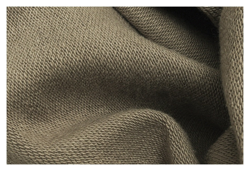 Close-up of the taupe fabric's textured knit surface.