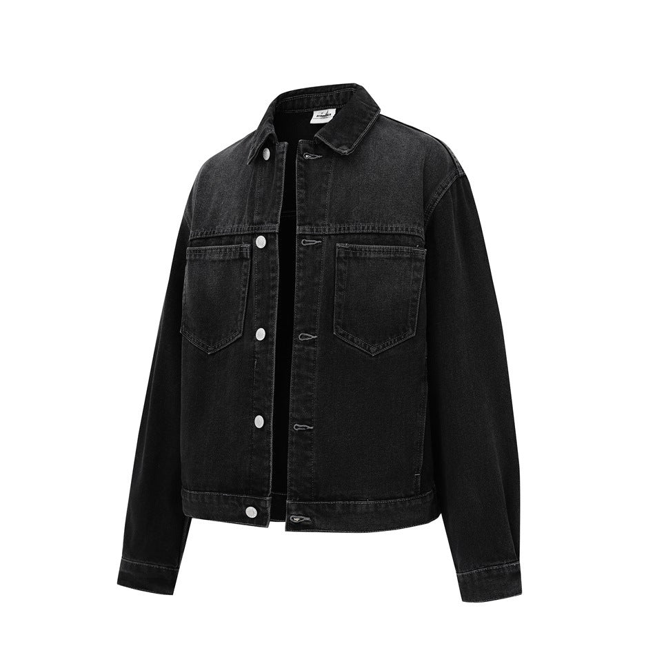 Black washed denim jacket in a three-quarter view with the front partly unbuttoned, showing pockets and collar