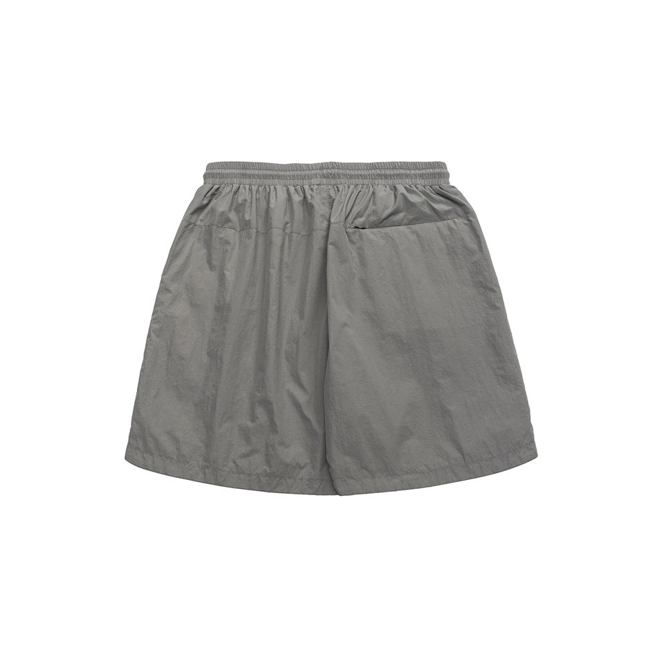 Back view of gray crinkled shorts with elastic waistband and a zippered back pocket