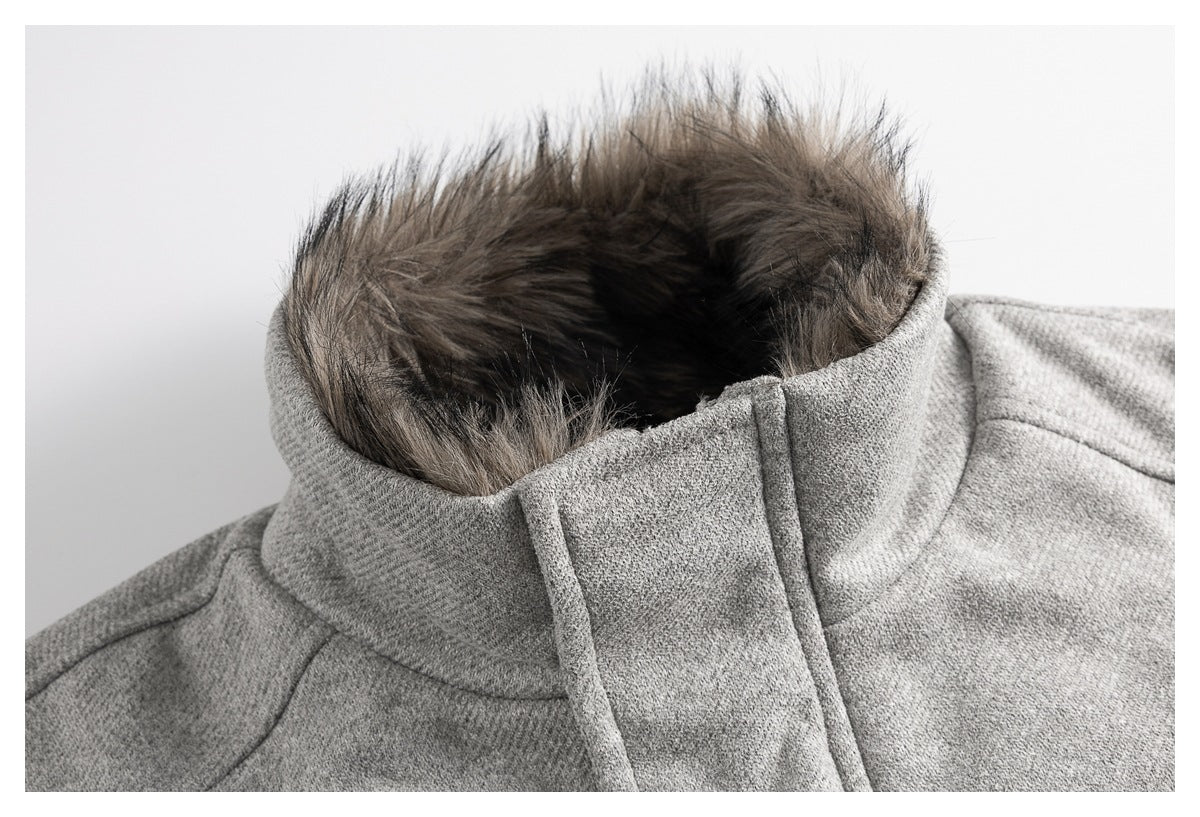 Close-up of a gray coat's high collar with a dark faux-fur trim.