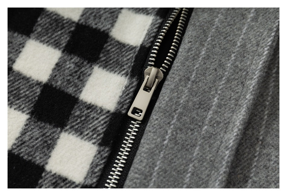 Close-up of a metal zipper between black, gray, and white check fabric and gray fabric.