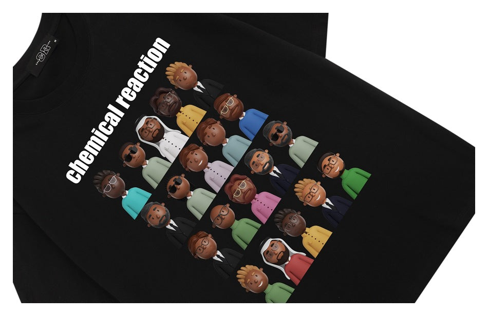 Angled flat lay of a black T-shirt with white “chemical reaction” text and a colorful cartoon group graphic.