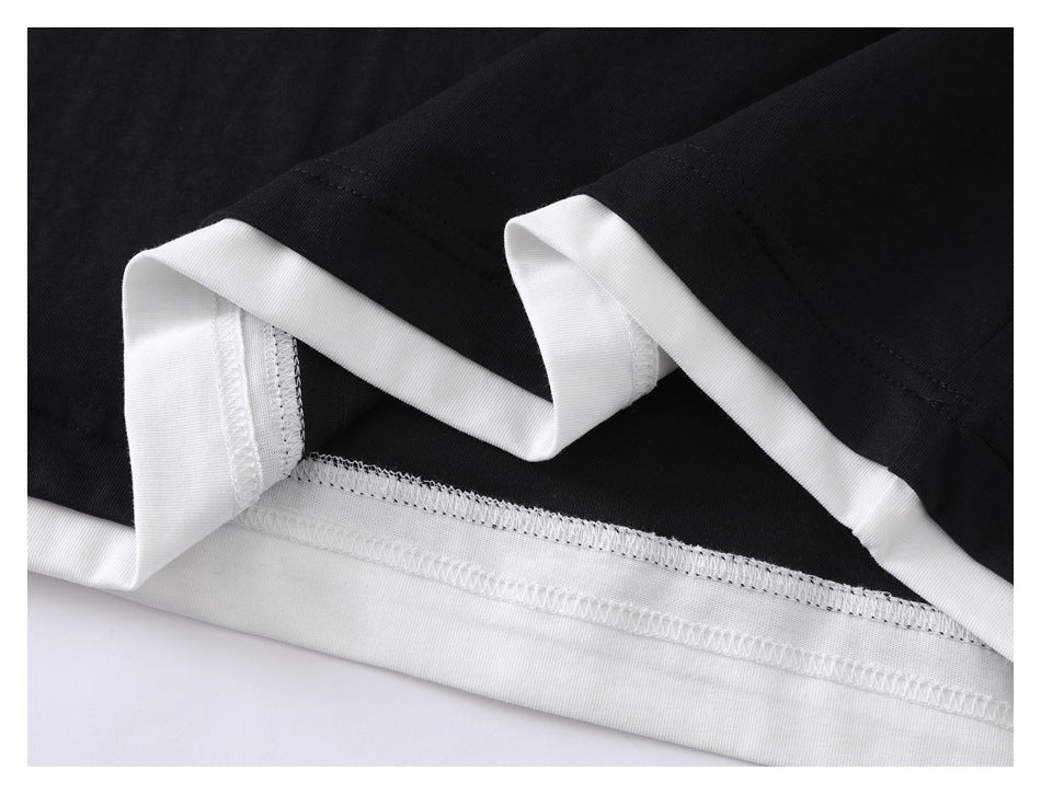 Close-up of a black garment hem with white binding and visible overlock stitching.
