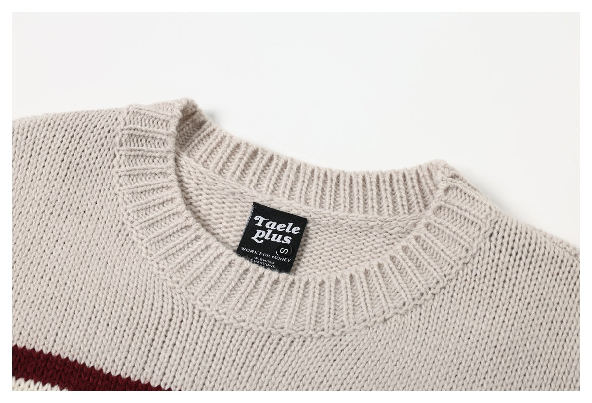 Close-up of a cream knit sweater's ribbed crew neck and sewn-in black neck label.
