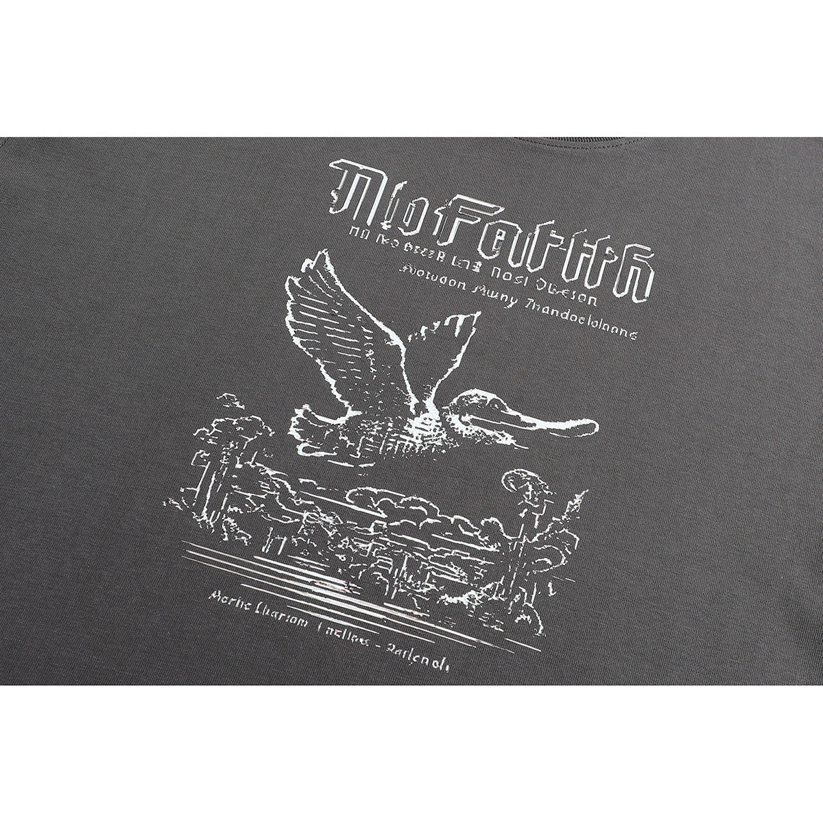 Close-up of a white graphic on charcoal gray fabric, showing stylized lettering and a bird in flight.