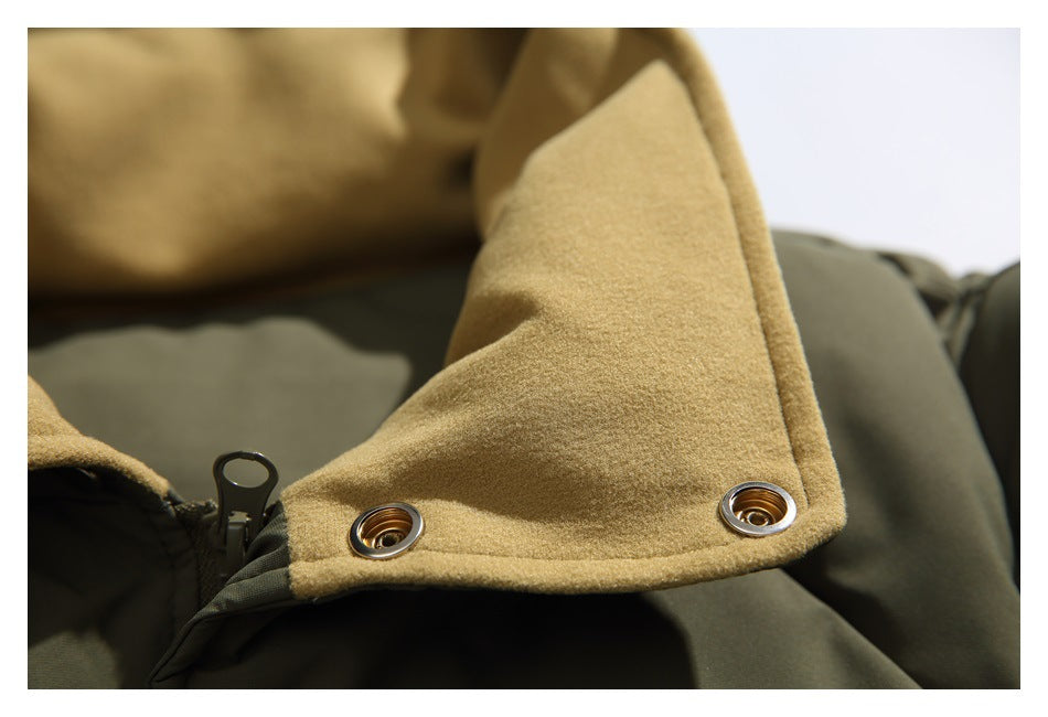 Close-up of the jacket’s tan lining, zipper, and metal snaps on the olive outer fabric.