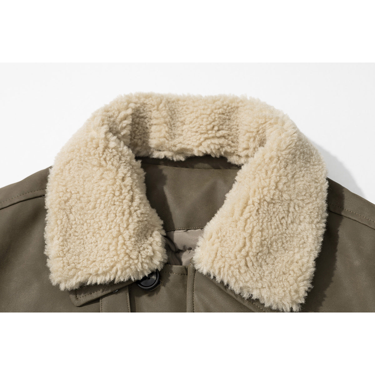 Close-up of a taupe coat with a thick cream fleece collar and dark button.
