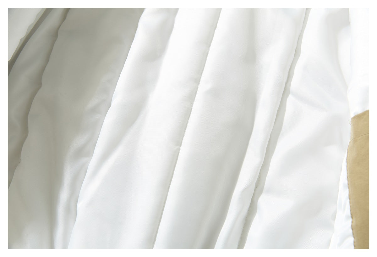 Close-up of the jacket's white quilted lining and khaki outer edge.