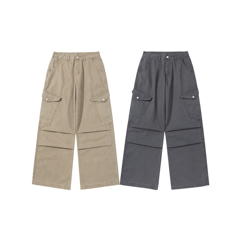 Front view of wide-leg cargo pants in taupe and charcoal gray, each with flap thigh pockets and roomy legs.