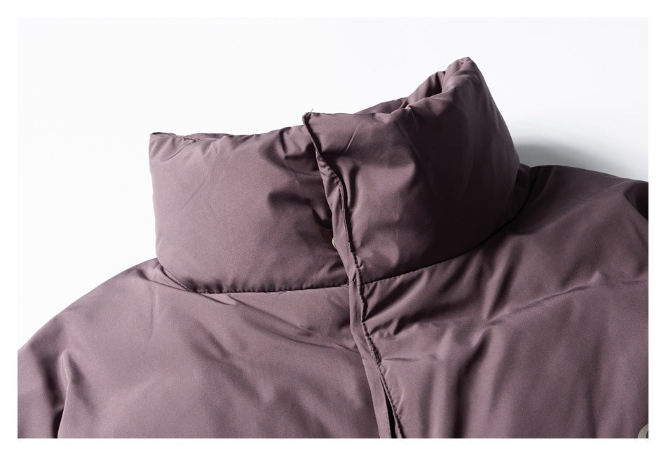 Close-up of the mauve padded jacket's high collar and front placket.