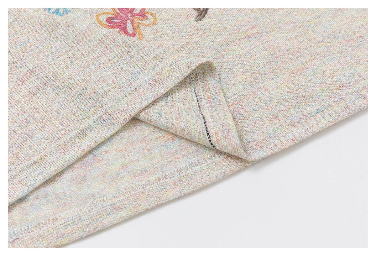 Close-up showing the inside overlock stitching and folded edge of pale speckled fabric.