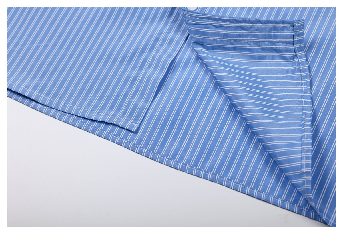 Close-up of blue-and-white striped shirt fabric with a folded panel and stitched edge.