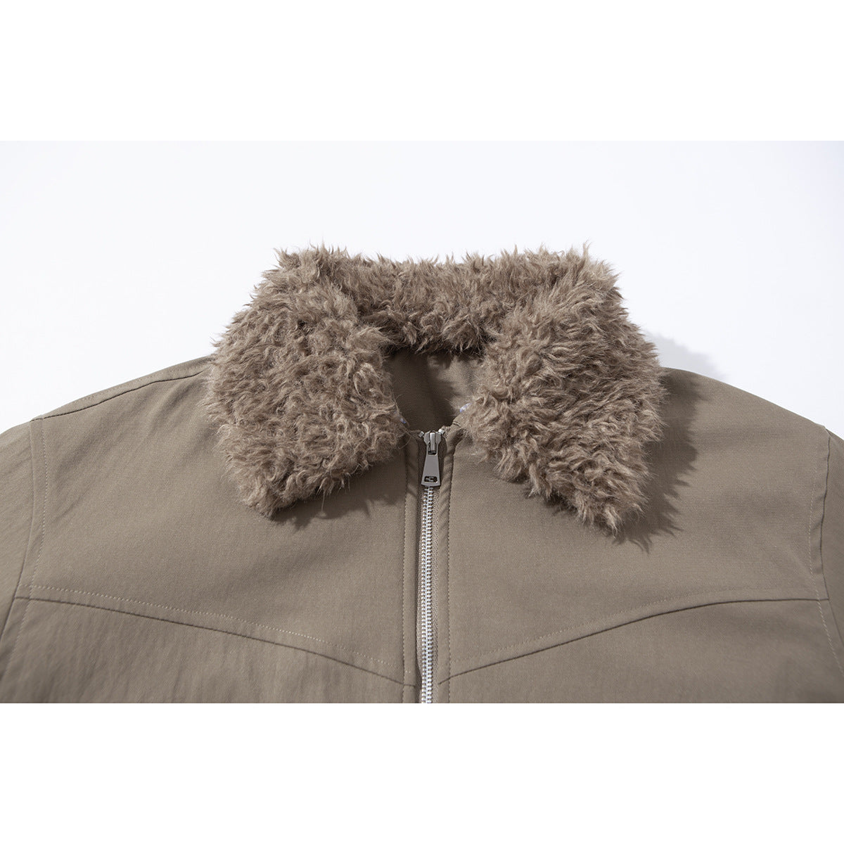 Close-up of a taupe jacket’s shaggy tan collar, front zipper and curved chest seam.