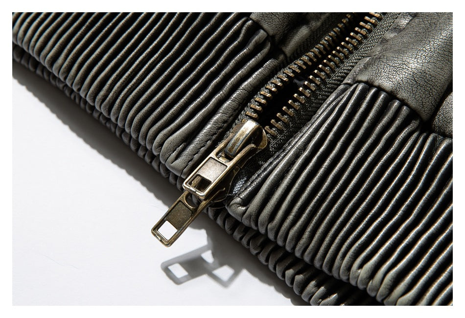 Close-up of the jacket's ribbed hem and long bronze-tone zipper pull.