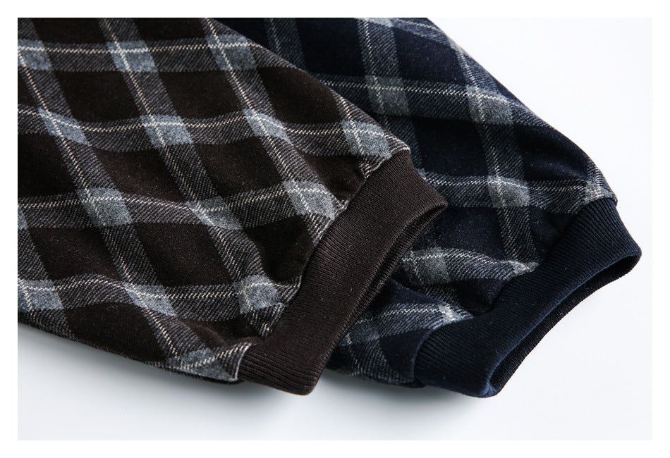 Close-up of black and navy plaid jacket sleeves with solid ribbed cuffs.