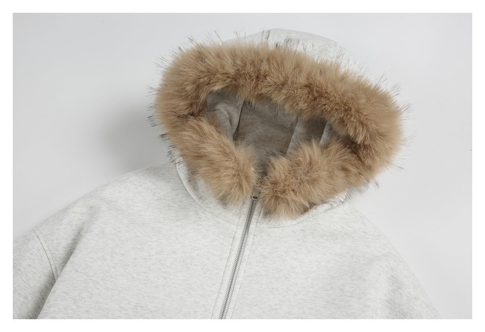 Close-up of a light gray zip-up hoodie with a large tan faux-fur-trimmed hood.