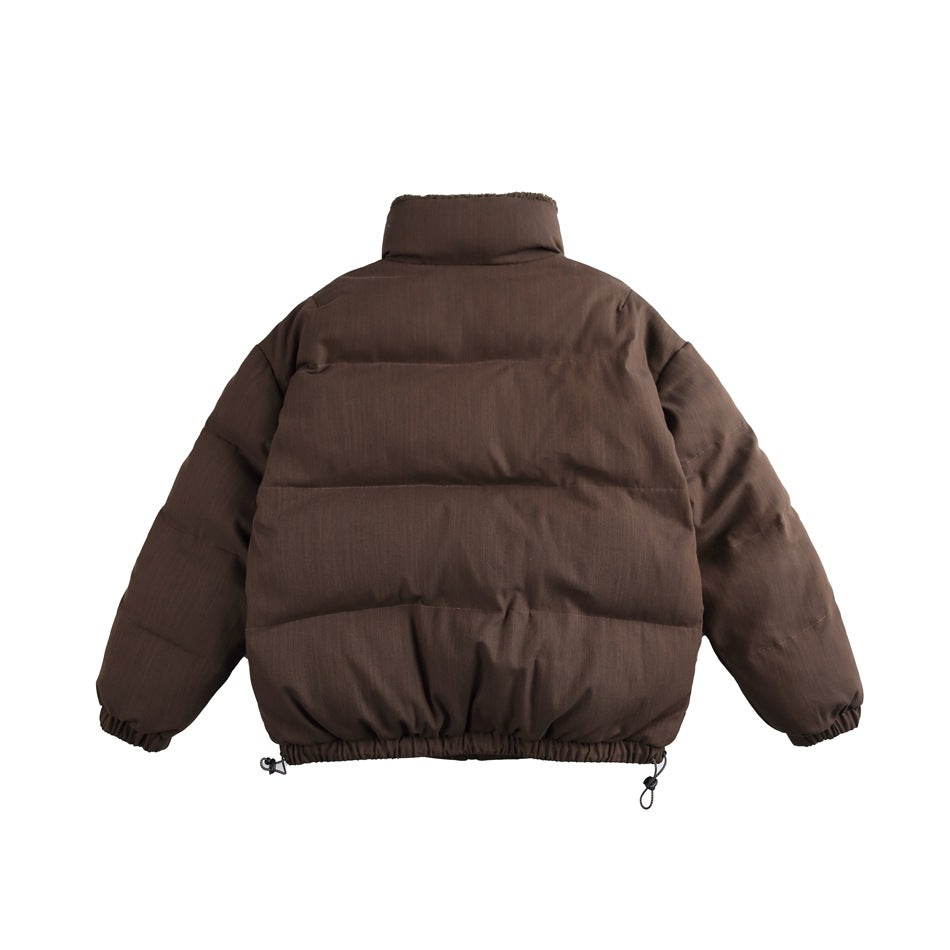 Back view of a brown quilted puffer-style jacket with stand collar, elastic hem and drawcord toggles