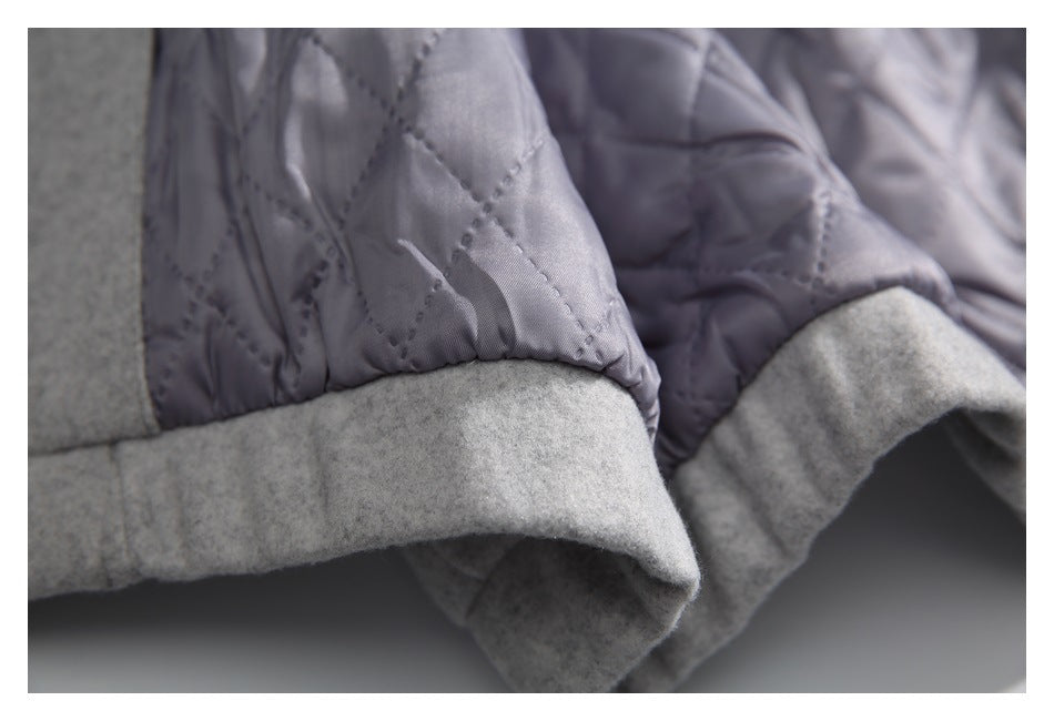 Close-up of a gray garment with diamond-quilted lining and a wide gray cuff.