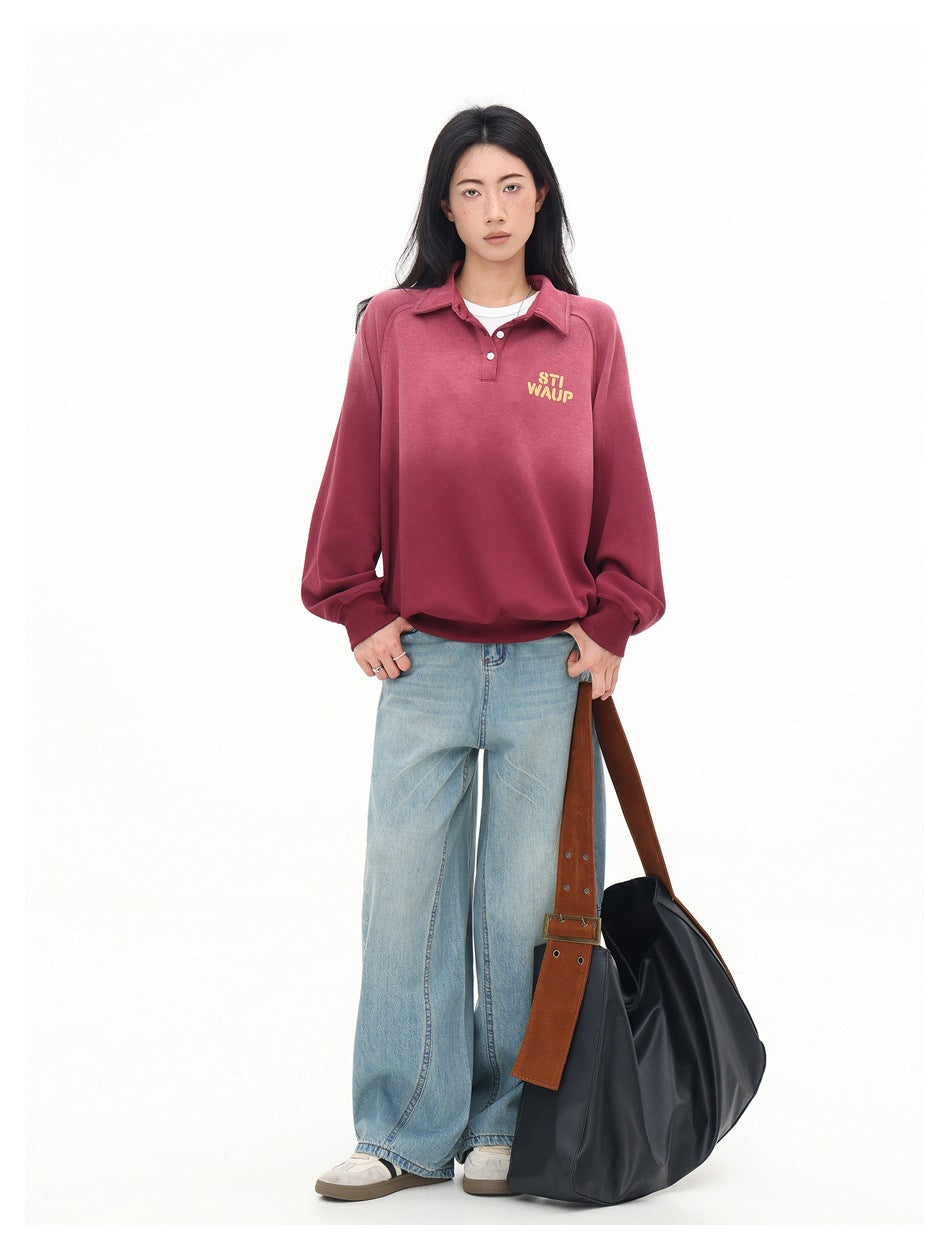 Full-length view of a woman in a red polo-collar sweatshirt, wide-leg light-wash jeans and a large black shoulder bag