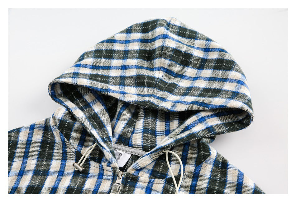 Cropped front view of a blue, cream and dark green plaid hooded jacket with a zip closure and drawstrings.