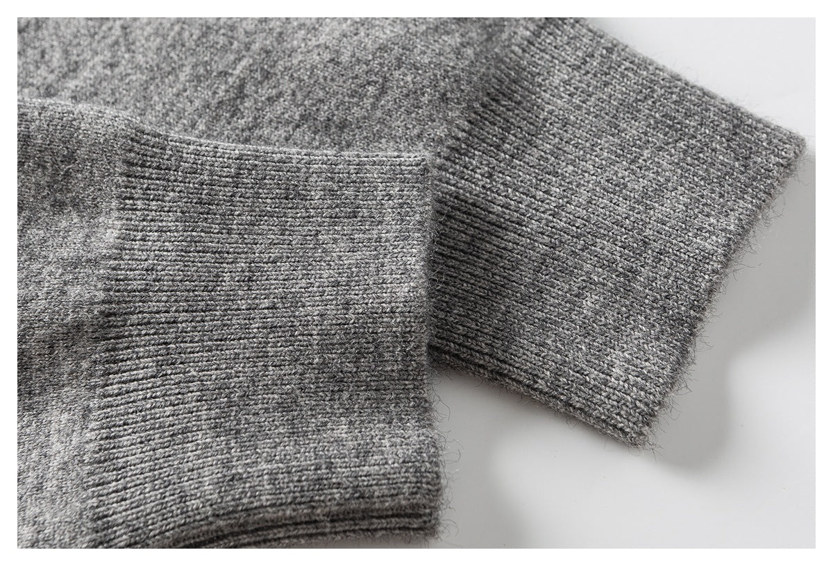 Close-up of a heather gray knit sleeve and its ribbed cuff.