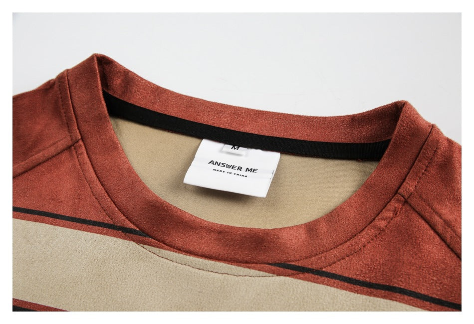Close-up of a rust-red striped T-shirt collar and its sewn-in label.