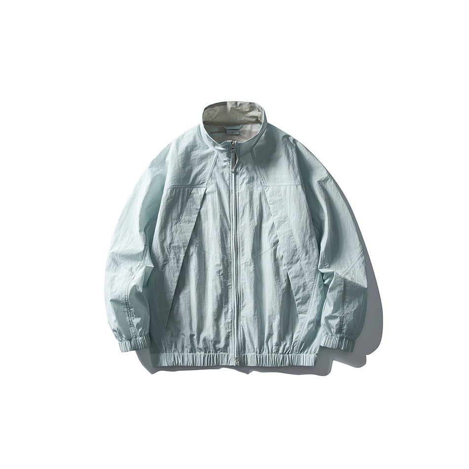 Glacier blue zip-up jacket with stand collar, paneled seams and elastic cuffs and hem