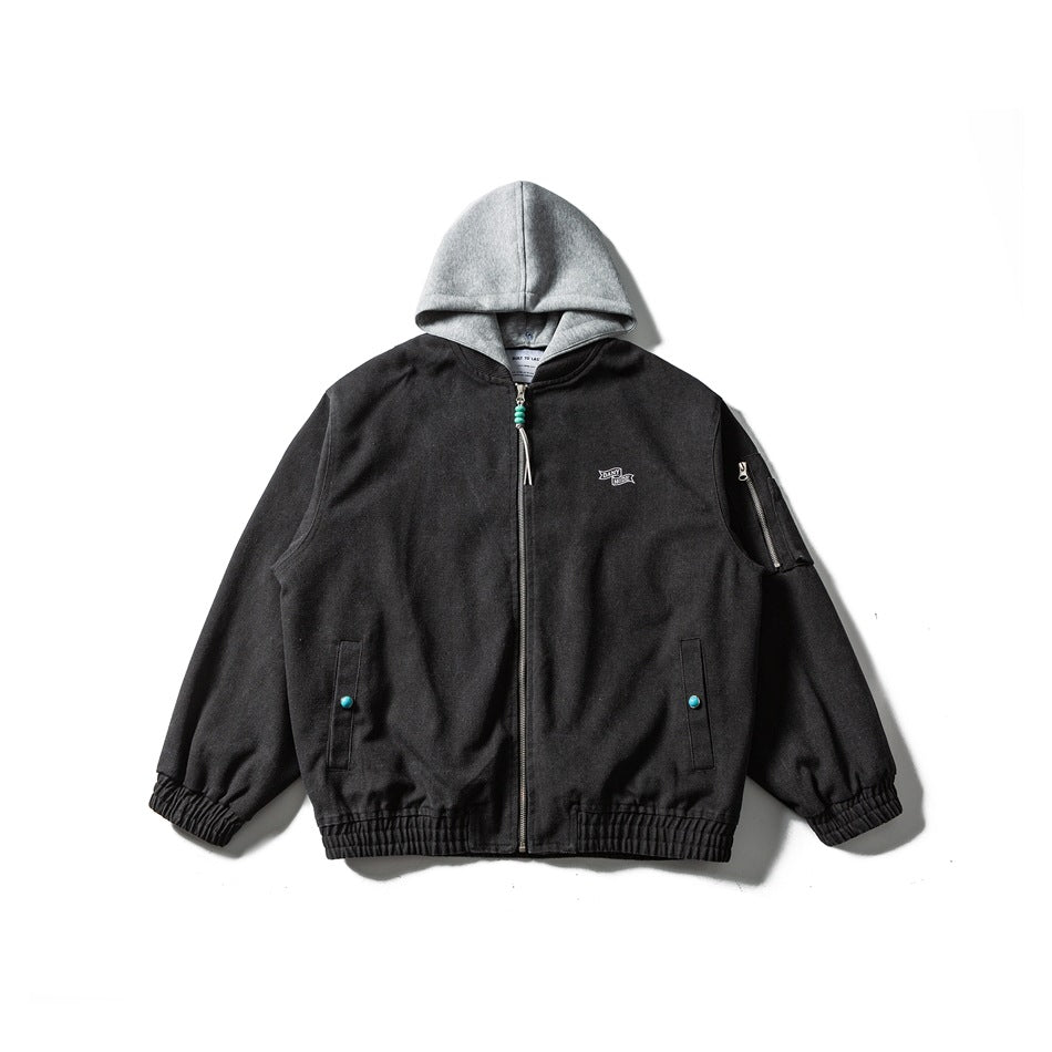 Black zip-front bomber-style jacket with gray layered hood, zippered sleeve pocket and turquoise snap buttons