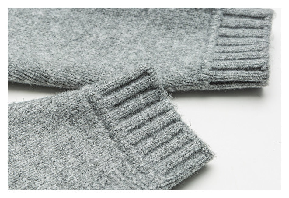 Close-up of two gray knitted sweater cuffs with ribbed edges on a white background.