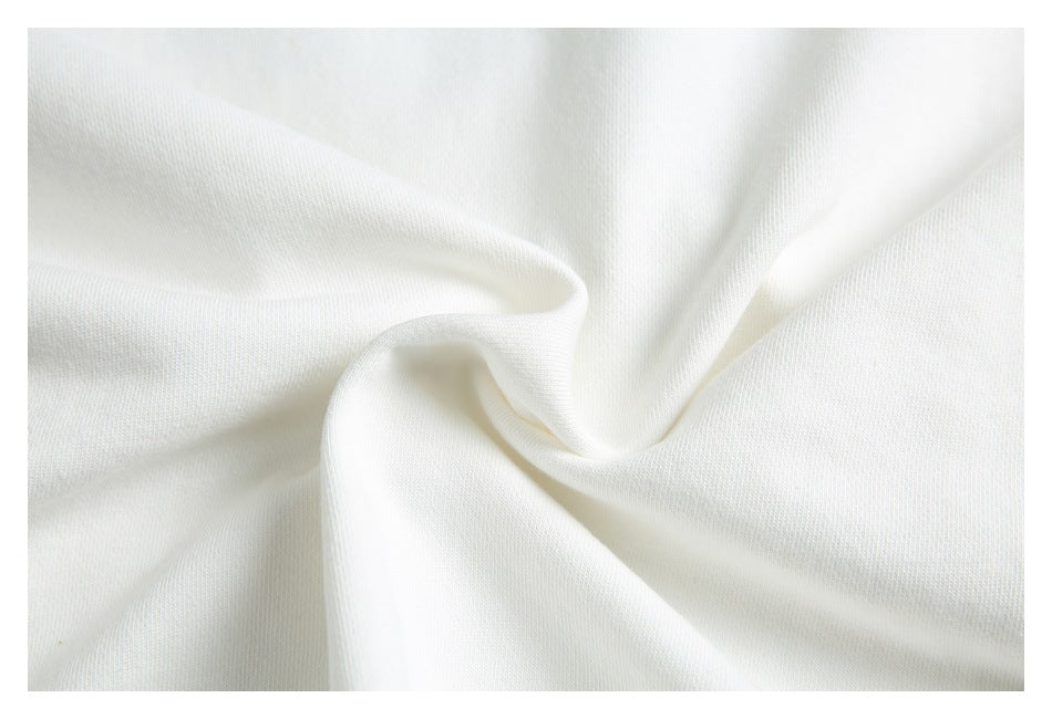 Close-up of softly draped white fabric showing its fine surface texture.