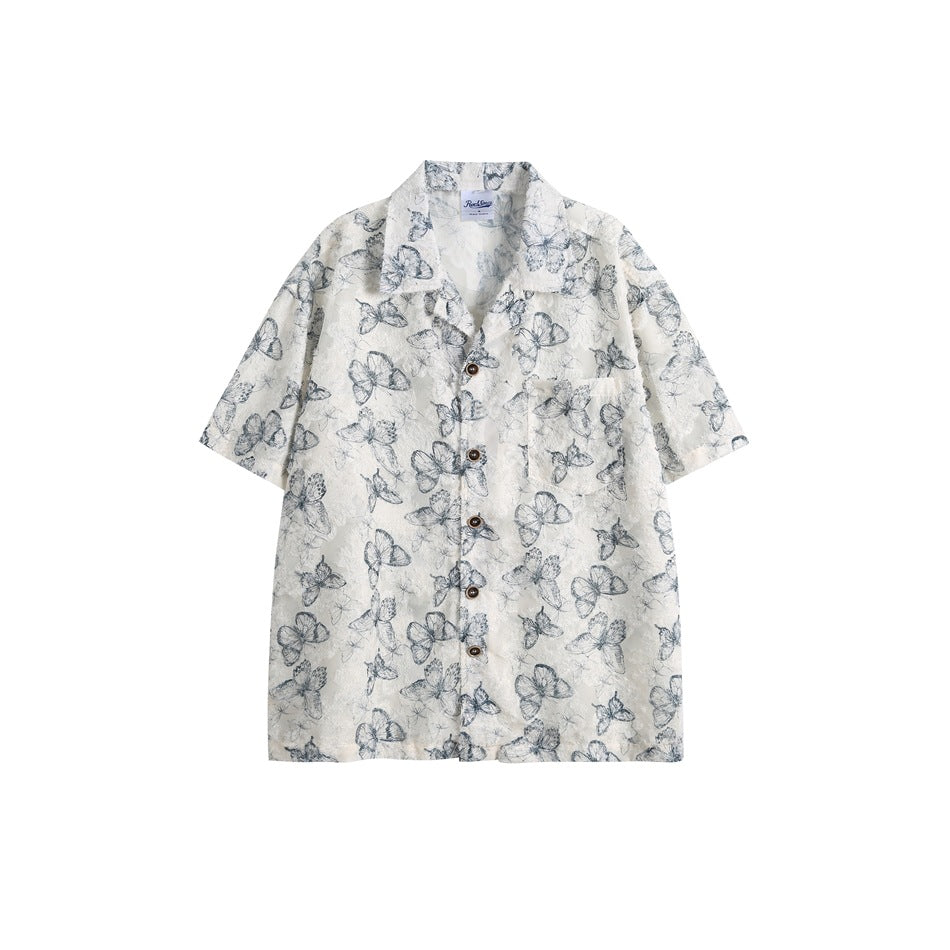 Blue butterfly-print short-sleeve button-up shirt with collar and chest pocket, flat front view