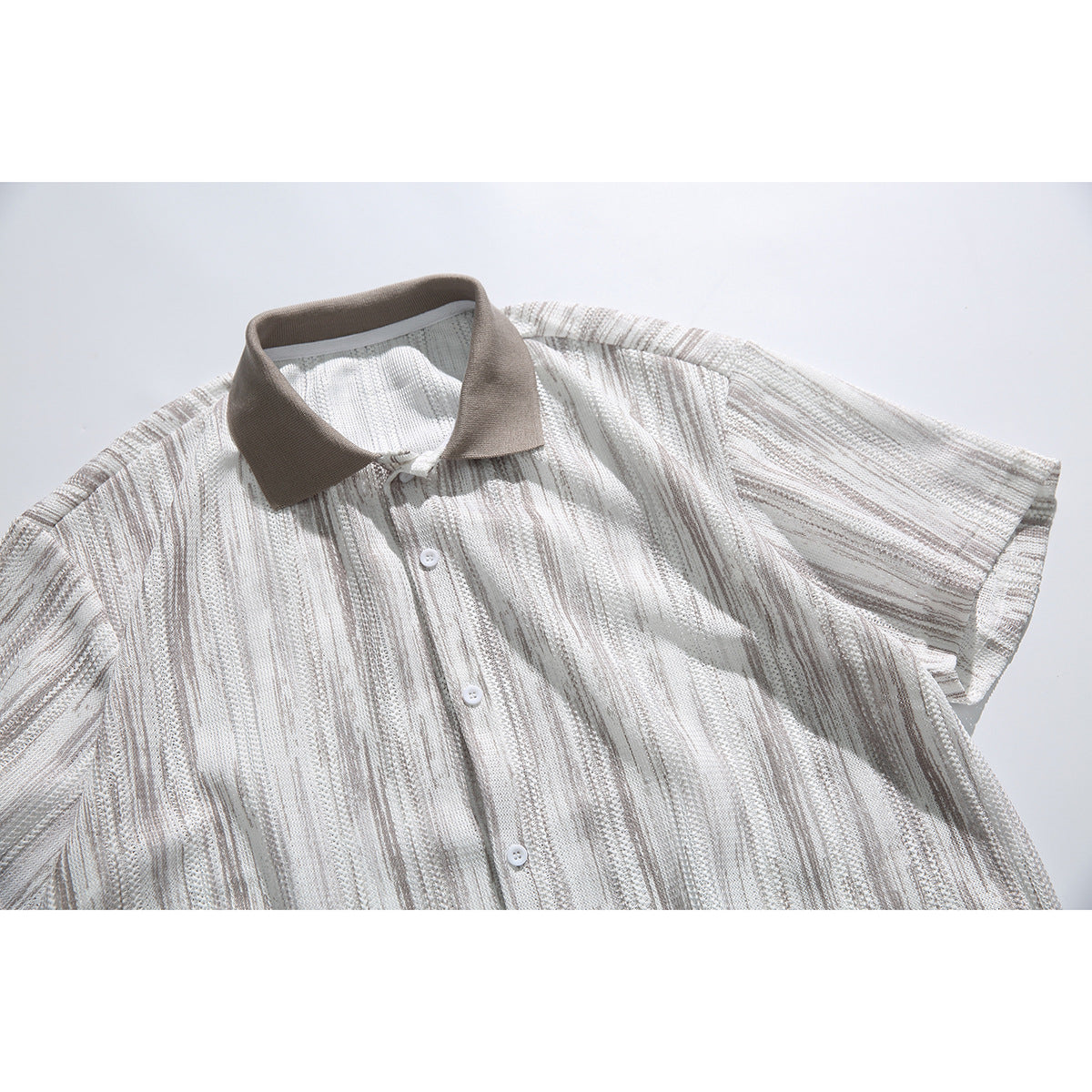 Close front view of a short-sleeve button-up shirt with cream and taupe vertical stripes and a taupe collar.