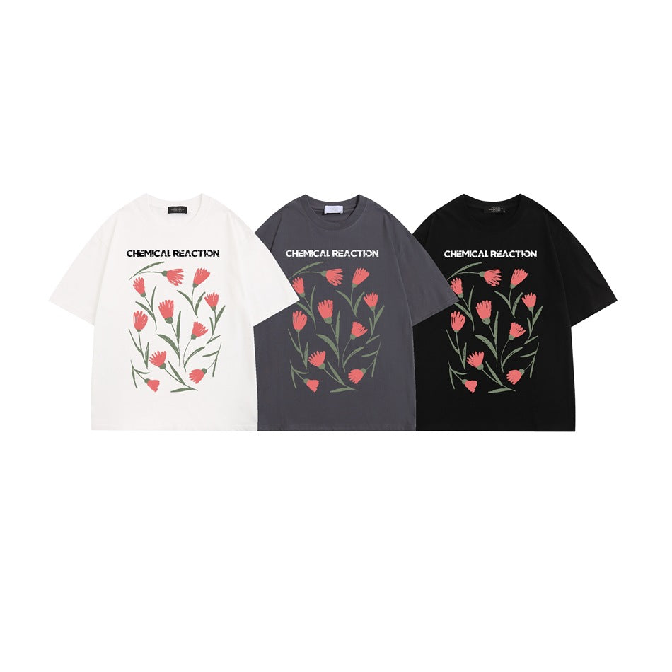 Three short-sleeve graphic T-shirts shown from the front in white, charcoal gray, and black.