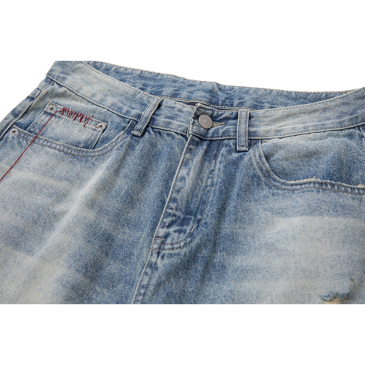 Close-up of the front waistband, button, fly and pocket of faded light-blue jeans with red stitching.