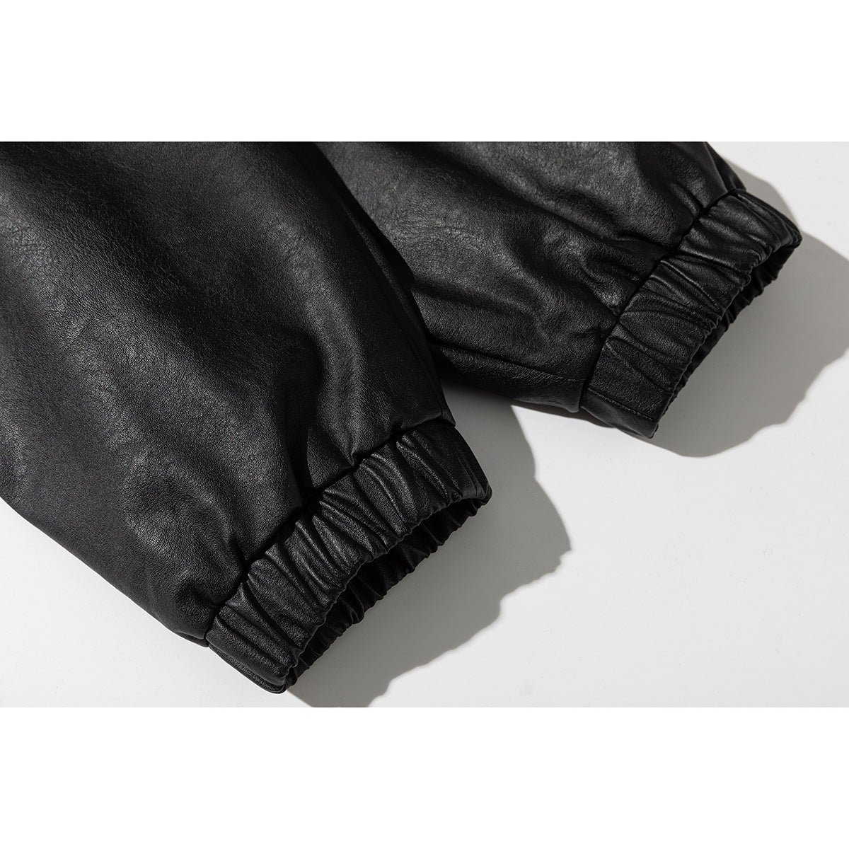 Close-up of a black jacket's gathered elastic sleeve cuffs.